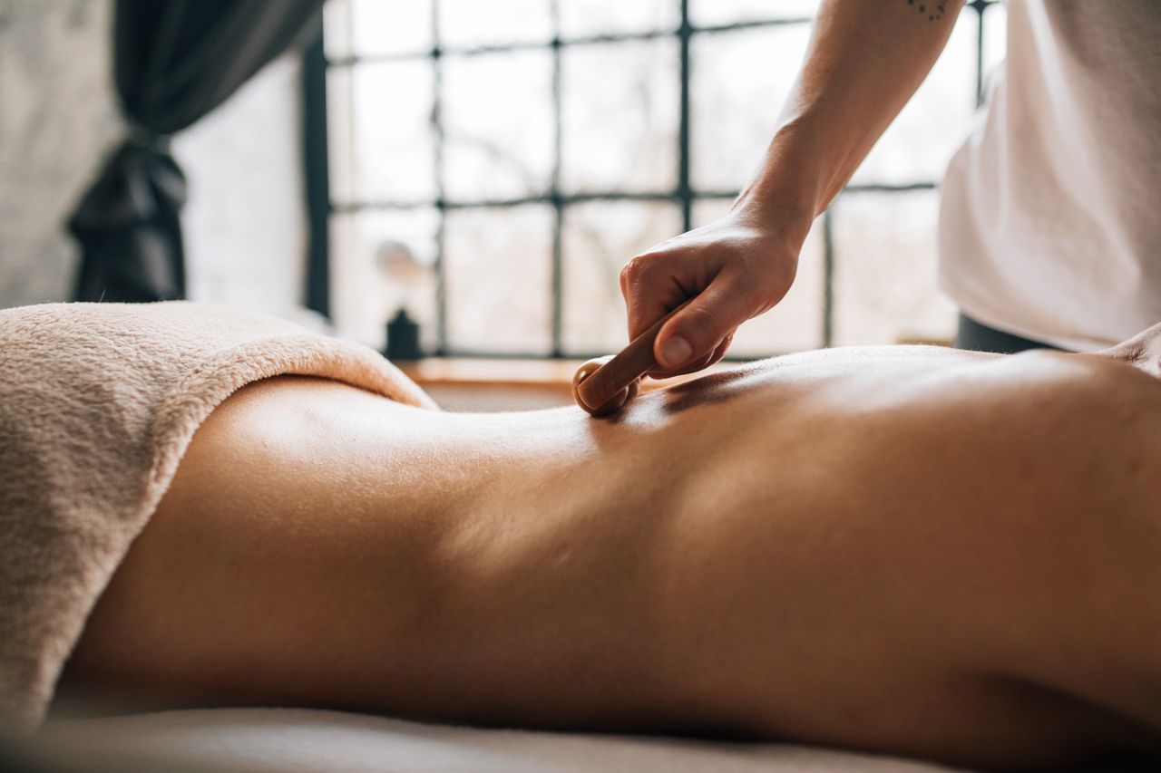 About A soothing body massage in a serene indoor spa setting, enhancing relaxation.
